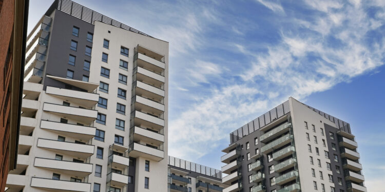 Exterior of modern houses in new area of the city. Architectural detail of windows, balconies. Real estate, residential apartment and office building architecture